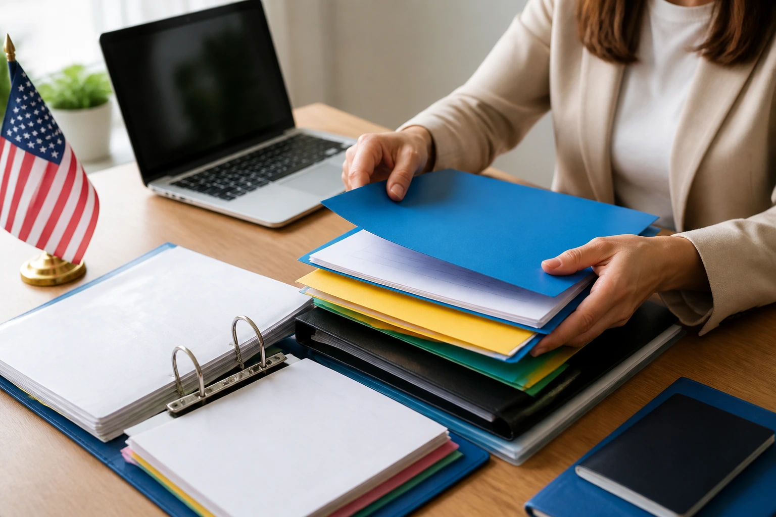 Hands organizing color-coded documents for sponsorship paperwork
