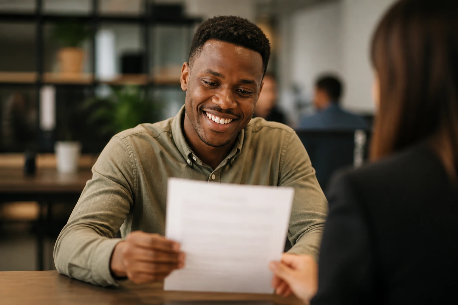 Person reviewing a contract with blurred text in an HR office