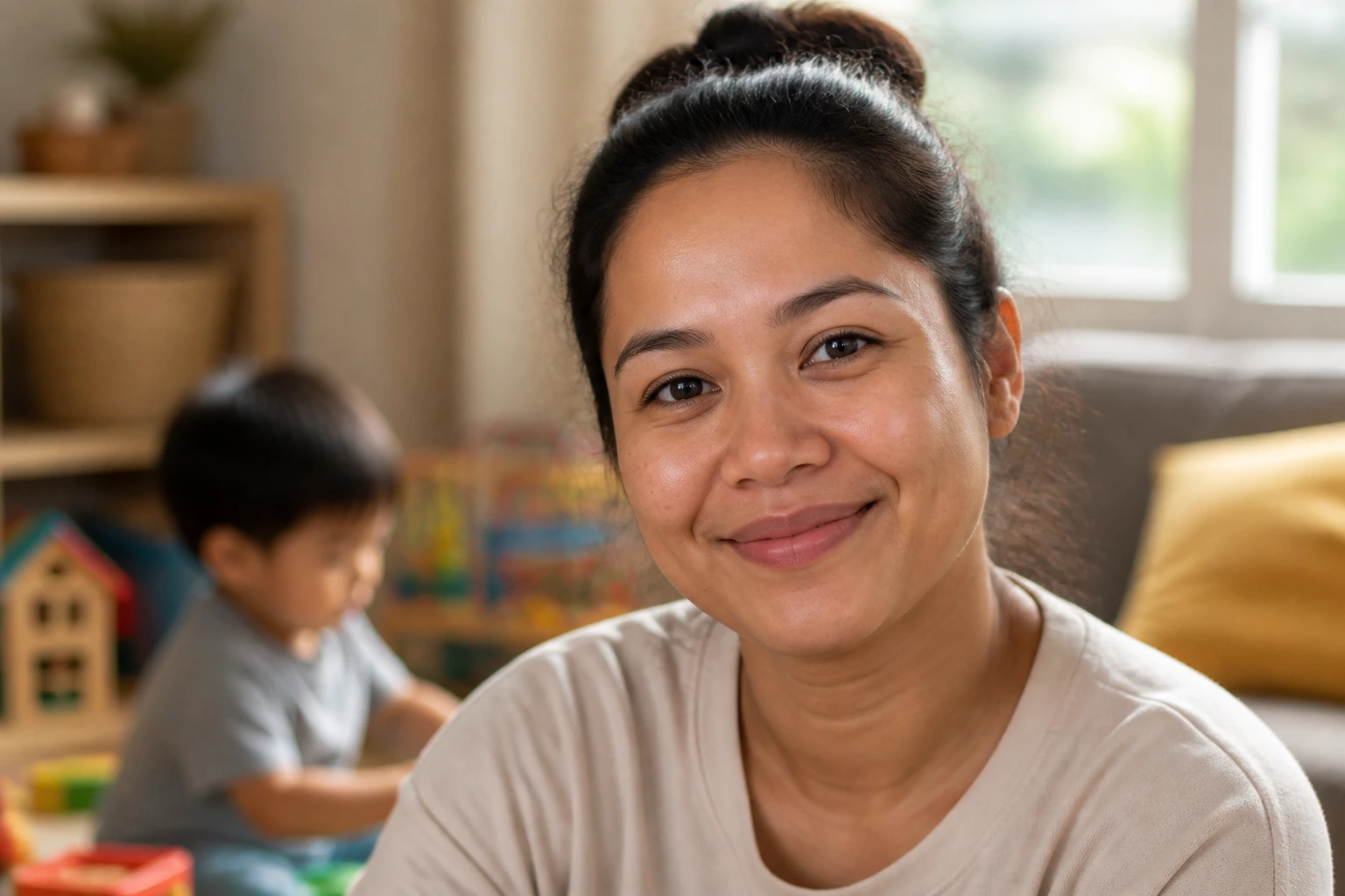 Close-up of a caregiver in a cozy home setting representing the child care pilot