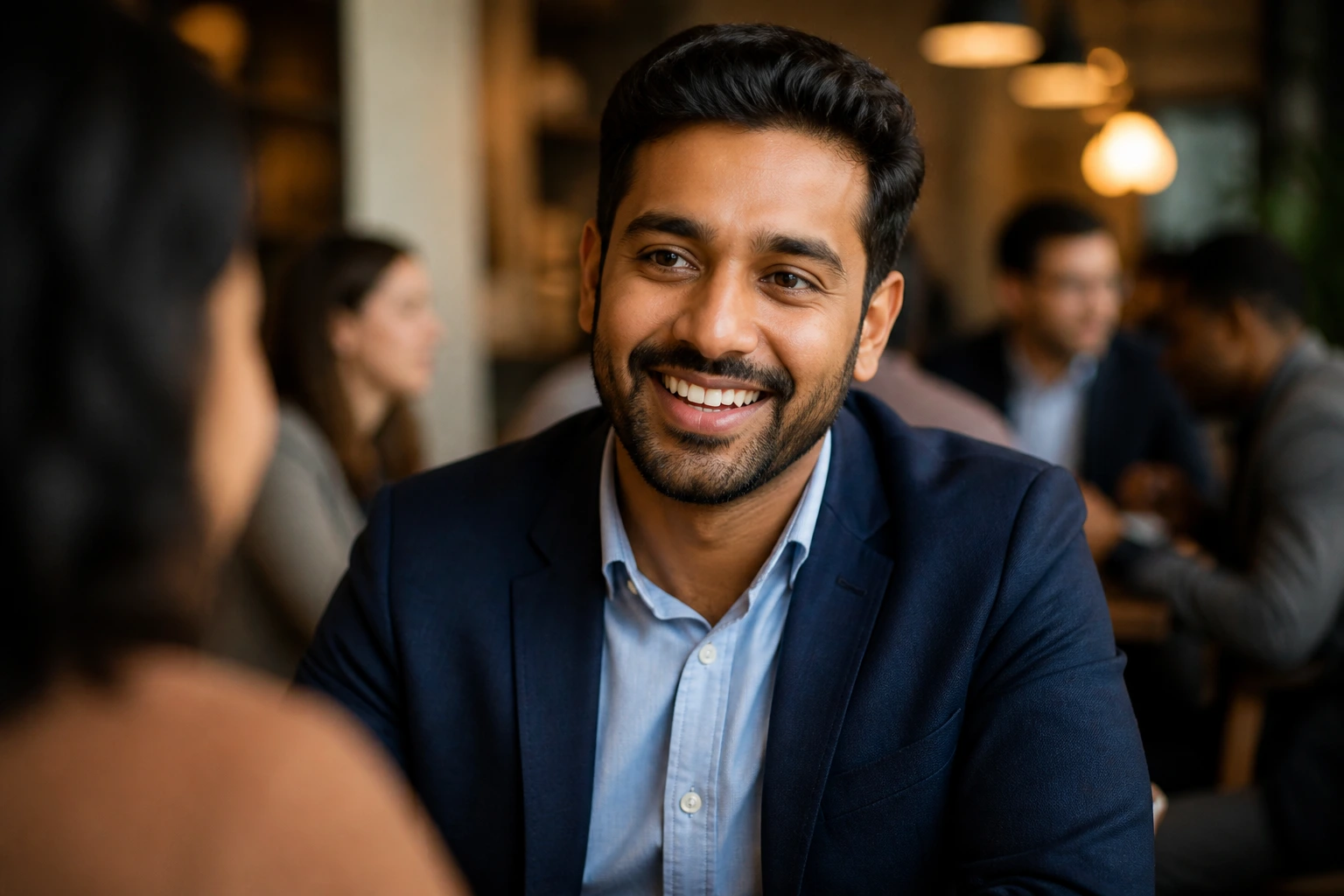 Professional portrait in cafe setting representing networking beyond job boards