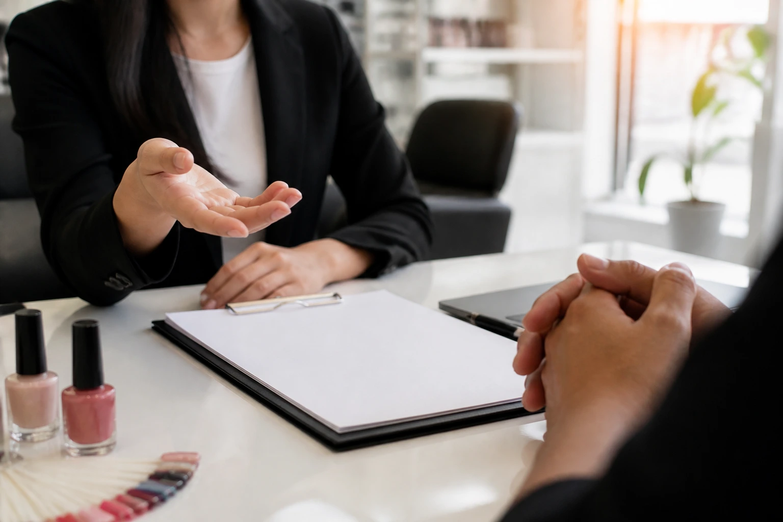 Hand gesturing toward a blank contract during an interview in an office