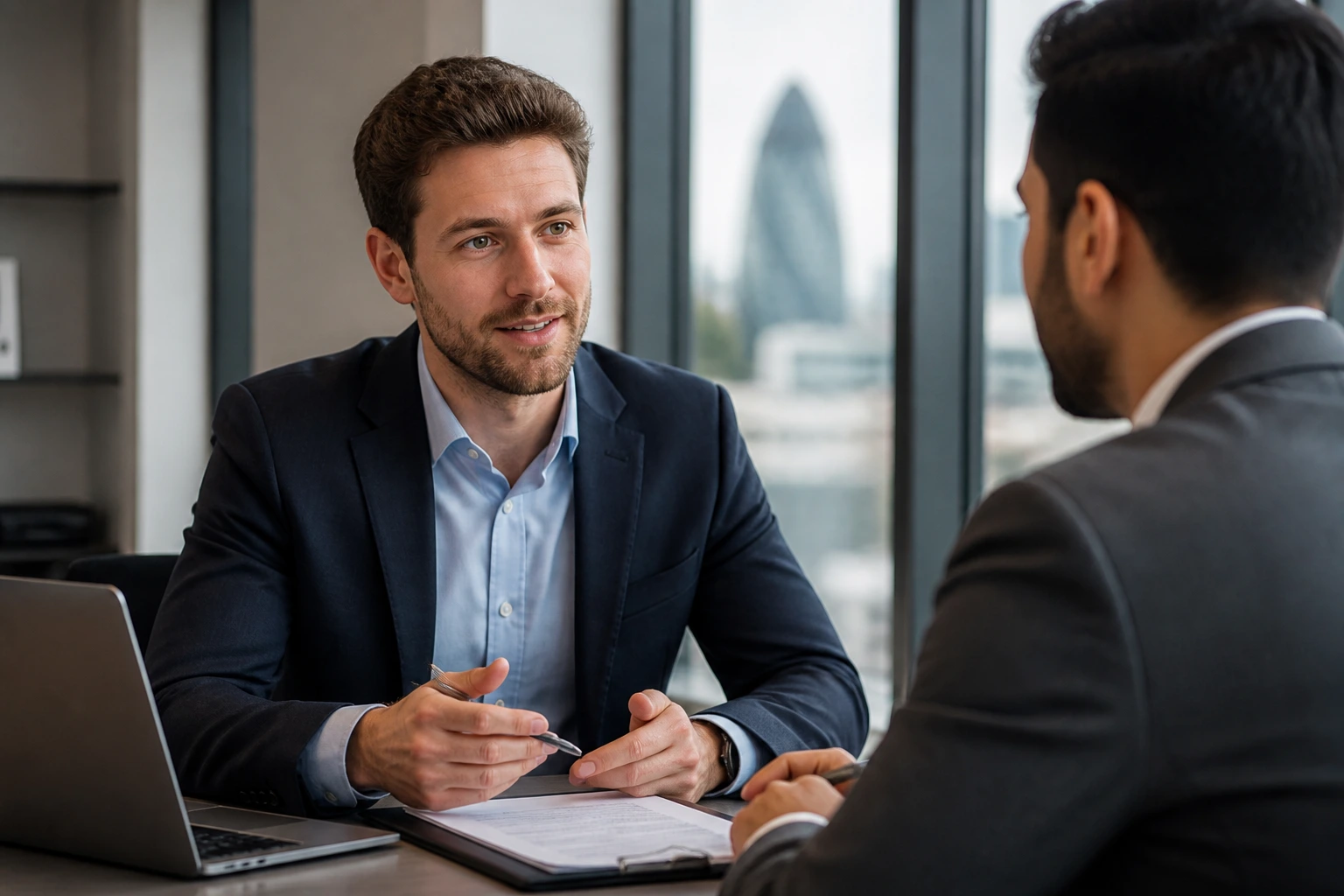Actuary consults with recruiter in a modern office