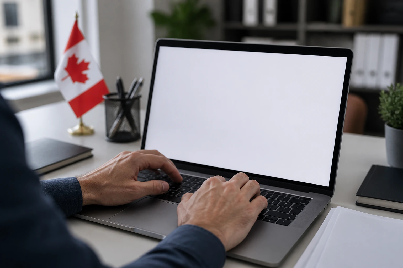 Person typing on a laptop in a tidy office