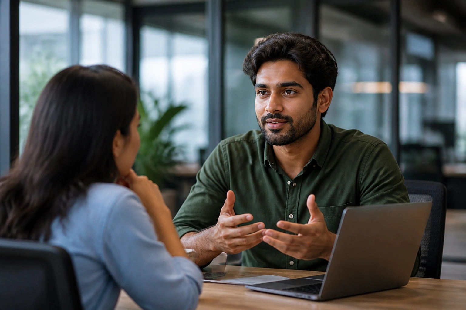 Portrait of a professional calmly discussing sponsorship in a meeting (no text)