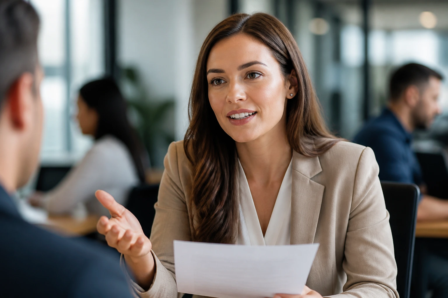 Recruiter explaining sponsorship pathways in a modern office