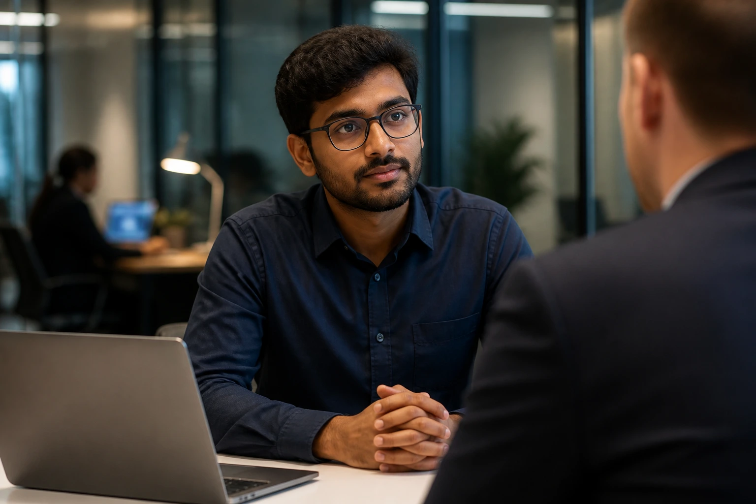 Medium close-up of candidate in interview room contemplating visa paths