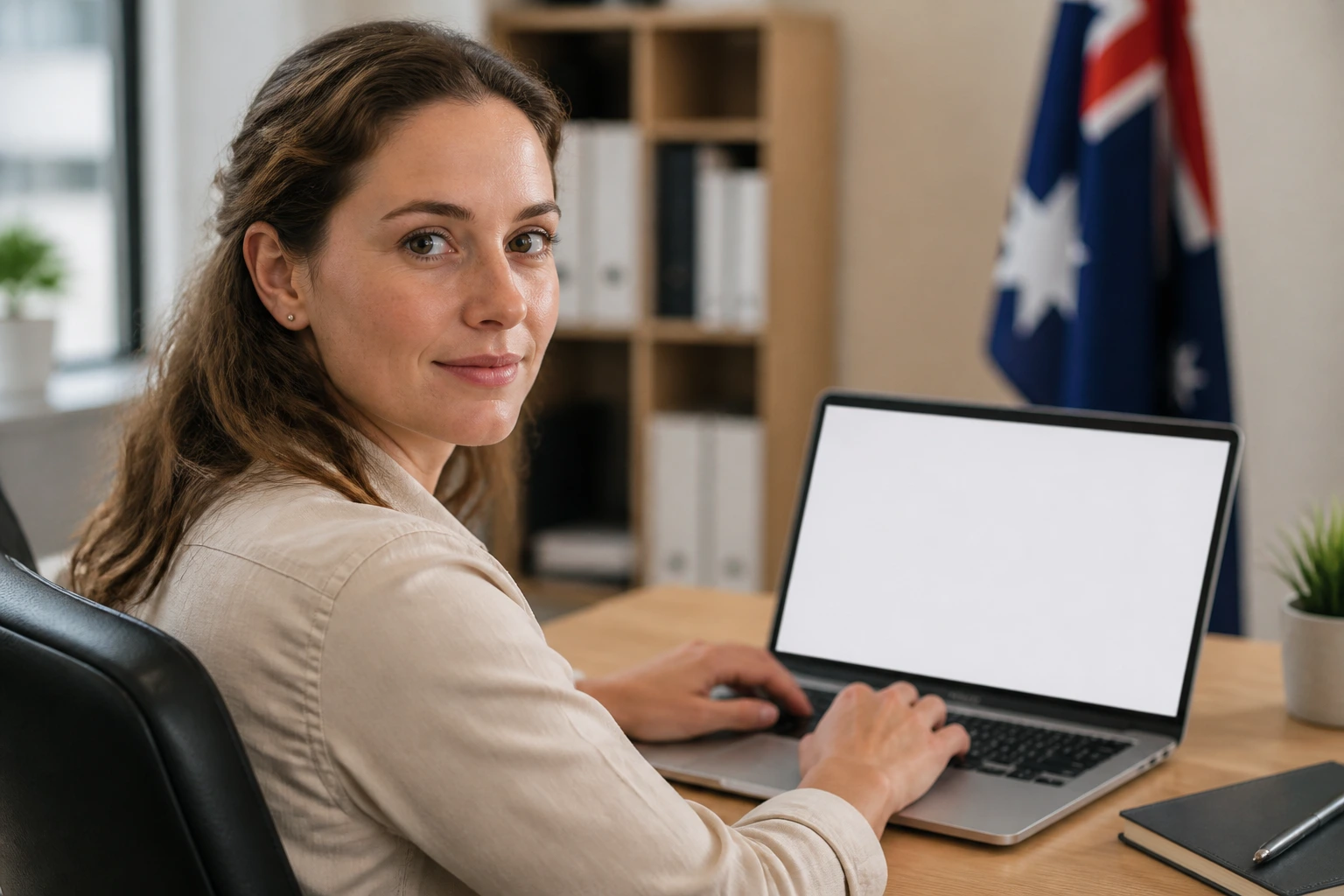 Close-up of a person in an office with a blank laptop screen
