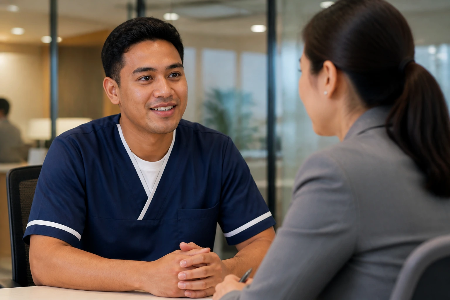 Orderly discussing visa sponsorship with an HR recruiter in a hospital setting