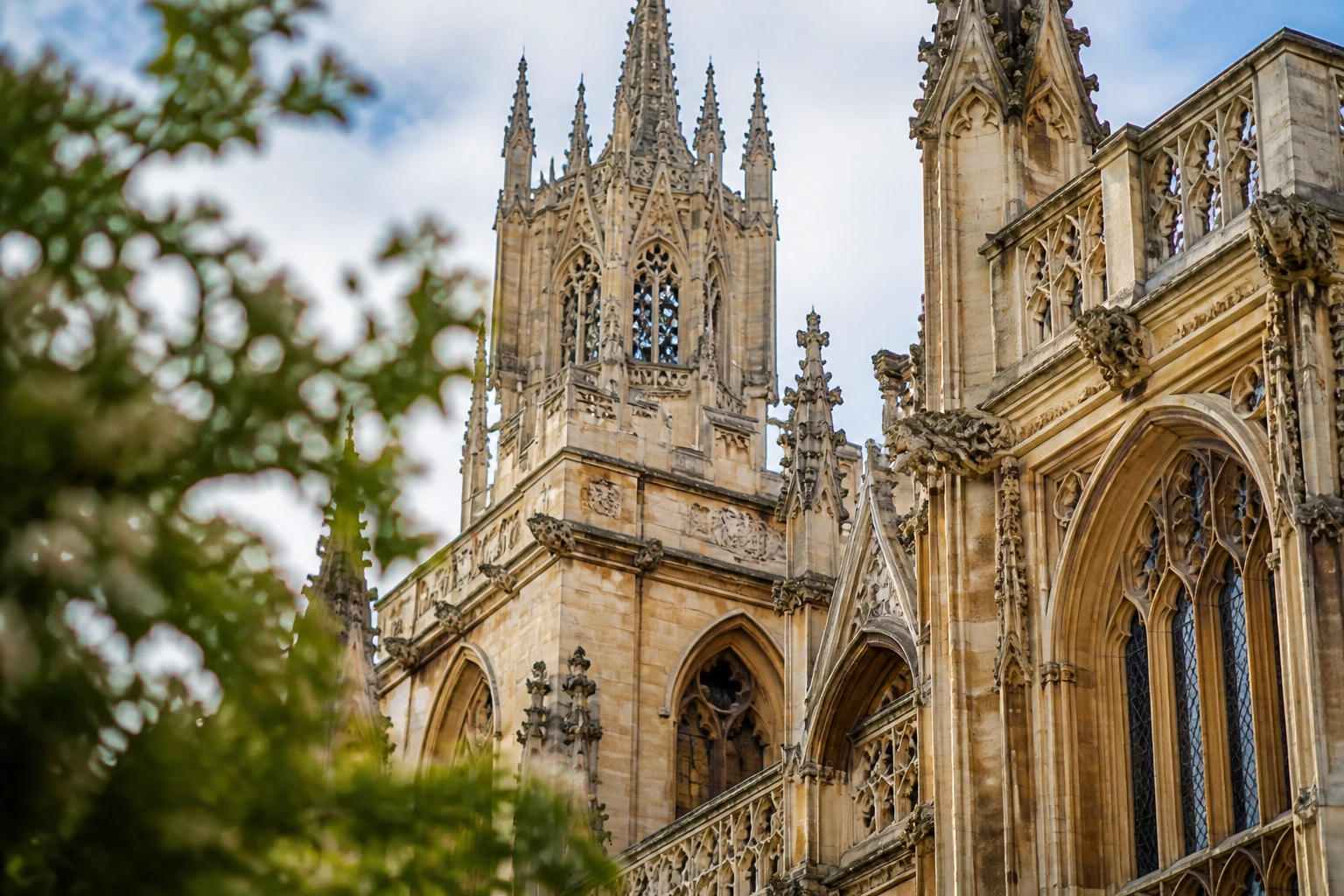 Close-up of Cambridge college spire and stonework in bright daylight